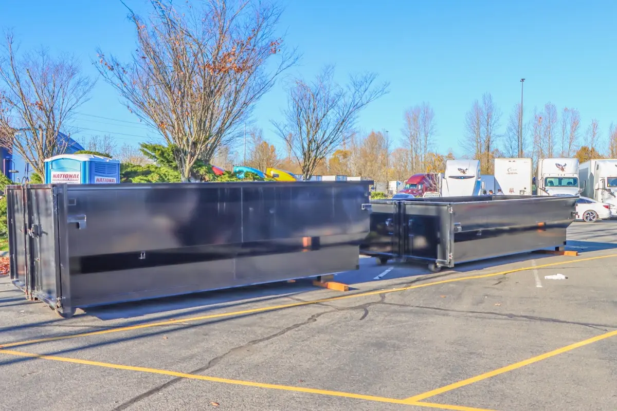 Professional dumpster rental service with roll-off container on residential driveway in Elkton